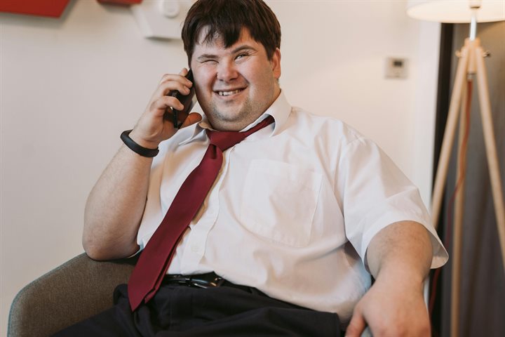 Man in shirt and tie using a phone